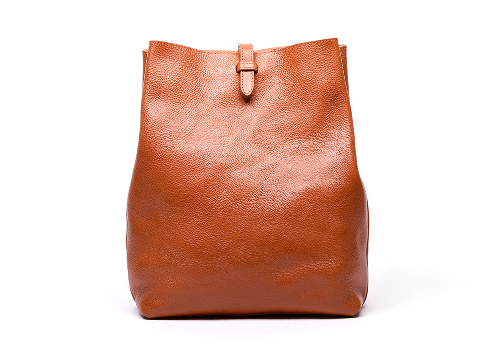 Front Leather View of The Sling Backpack Orange